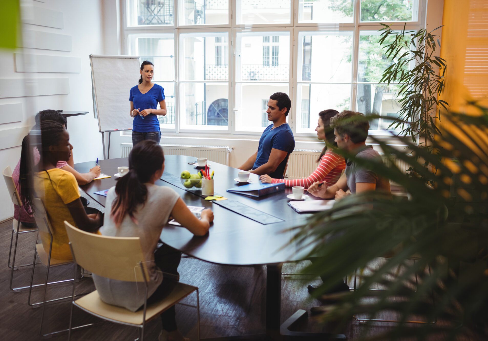 Business executives applauding their colleague after presentation in office