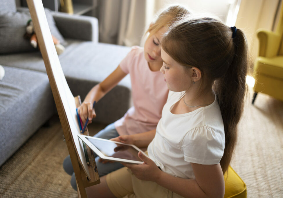 little-girls-drawing-using-easel-tablet-home (1)